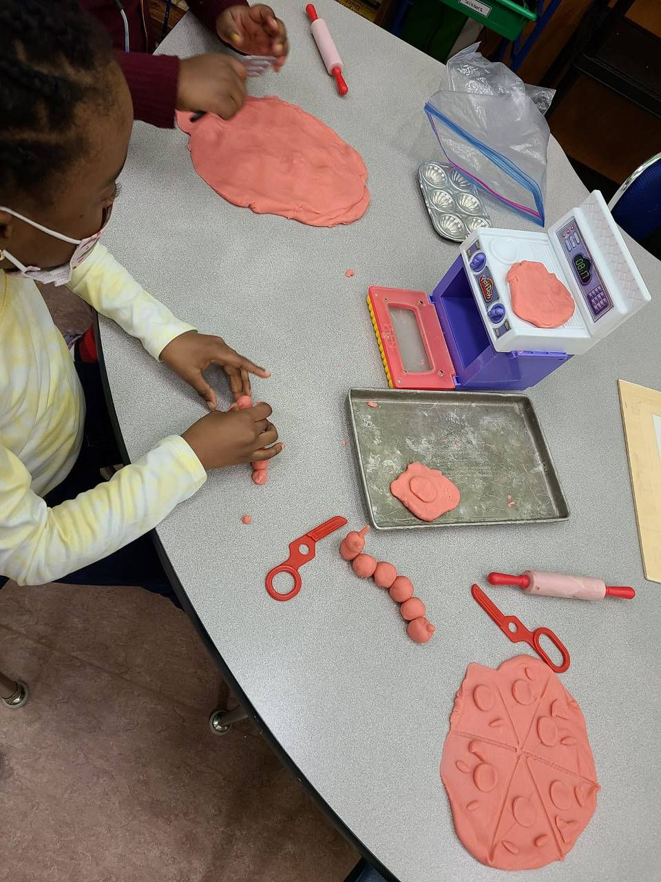 An image of kids playing with clay