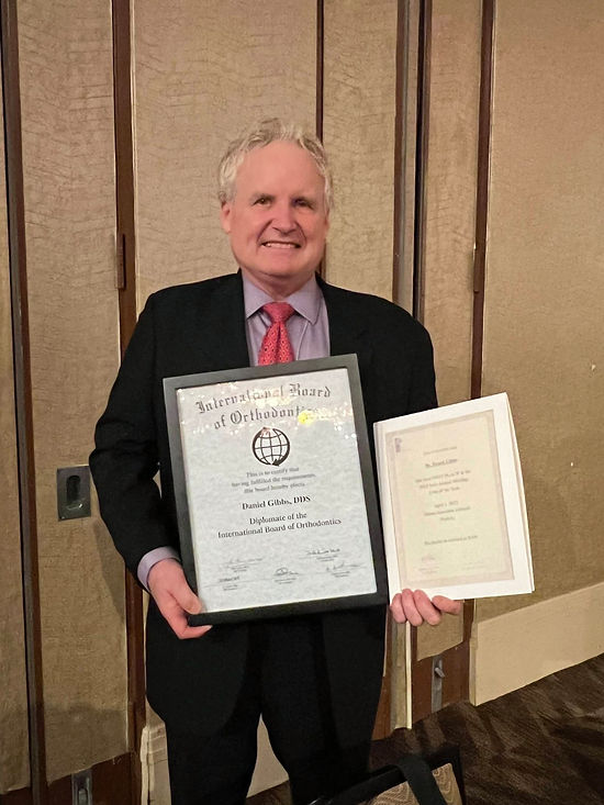 Dr. Daniel Gibbs with Award Certificates