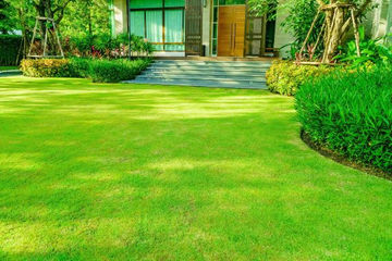 A photo of a lush green garden with uniformly cut grass