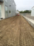 levelling dirt around stone wall