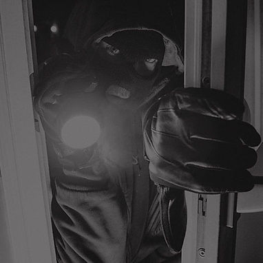 A burglar entering through a window