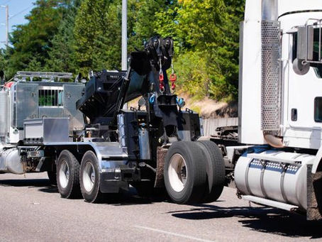Heavy-duty tow truck assisting a tractor-trailer