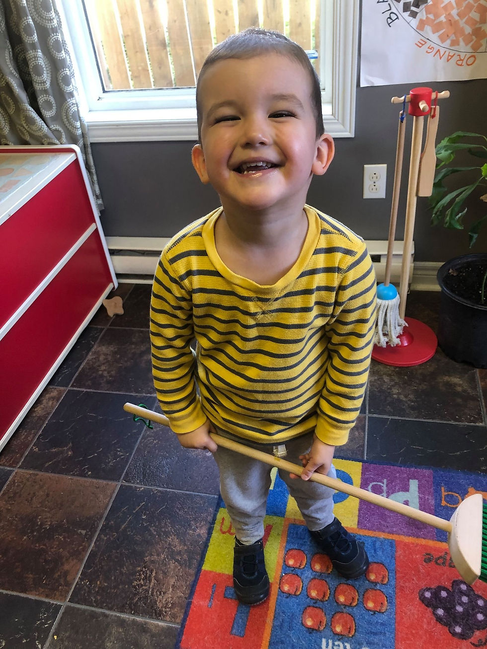 kid smiling and posing with cleaning stick