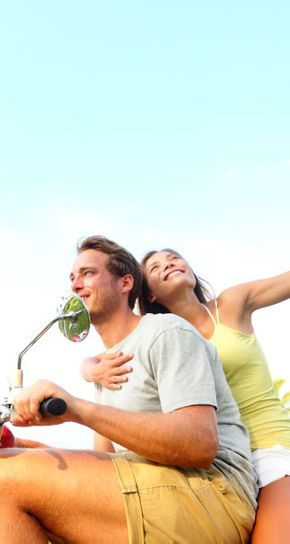 couple enjoying themselves on a scooter