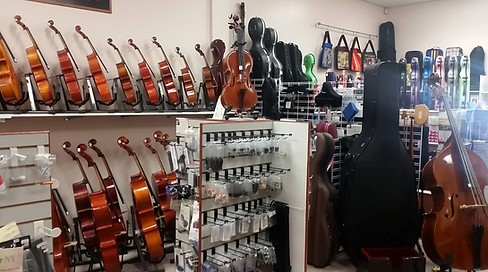 Close-up of piano keys, sheet music resting on a dark stage.