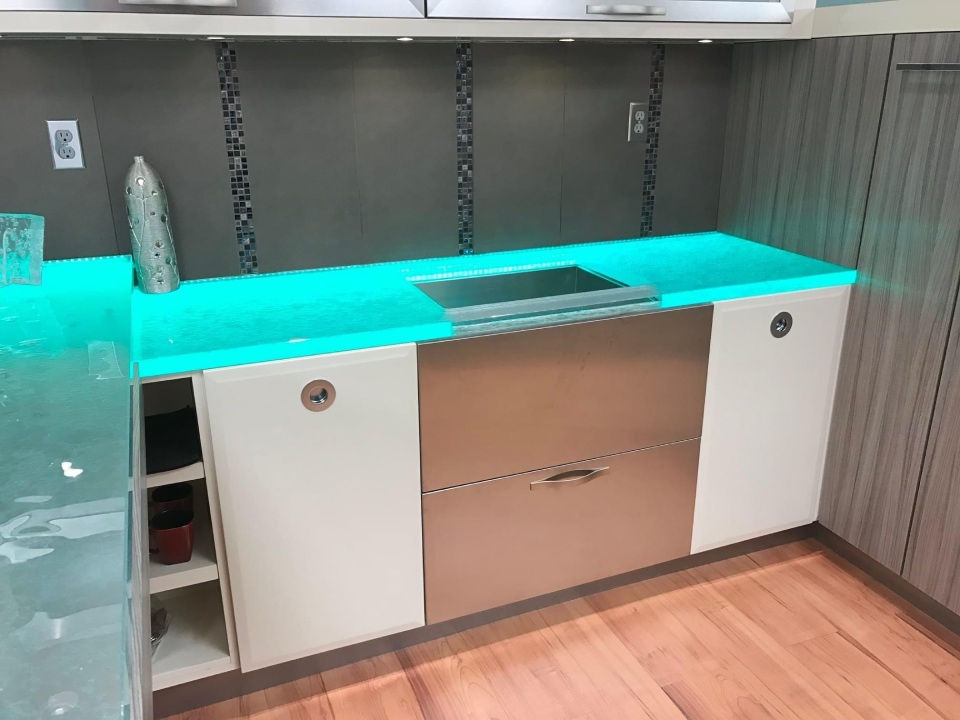 A glass countertop with blue lighting