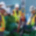 workers weighing heavy machinery on hanging scale