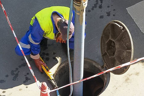 man cleaning a septic tank