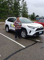 person standing besides a white car