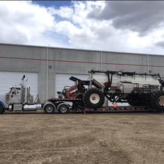 A large oil container loaded on the back of a trailer
