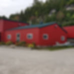 A picture showcasing a red-coloured newly painted house