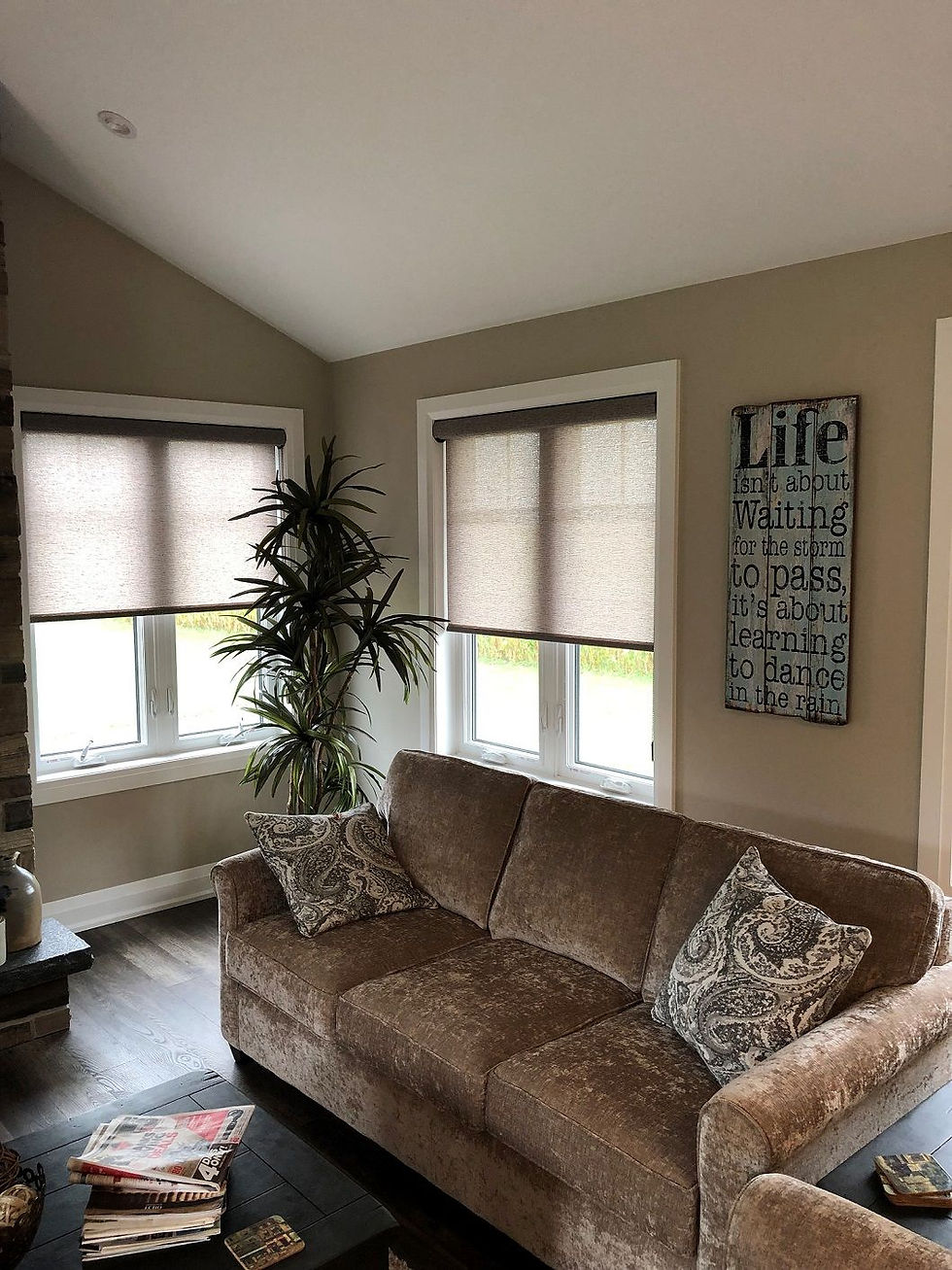 Living room corner windows partially covered with textured roller blinds
