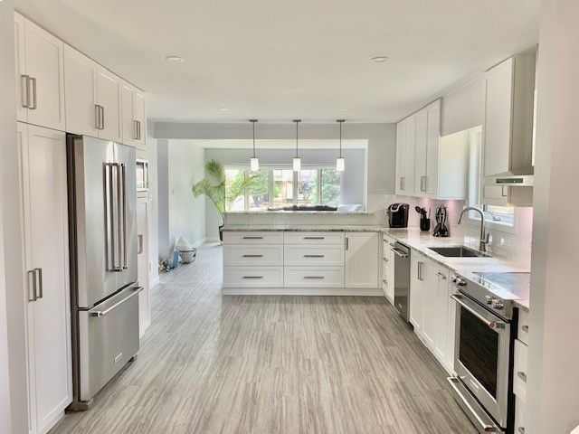 view of white kitchen cabinet with wooden floor