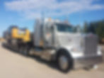 Semi-Truck with Cat Excavator on Trailer