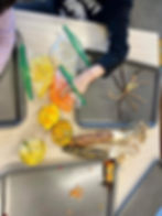 An image of a kid creating corn using beads