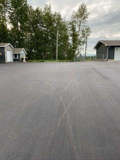 view of asphalt road to a house