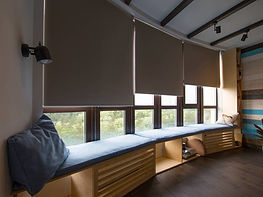 Wooden window blinds suspended in a step-manner against the glass windows.