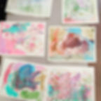 A view of several paintings of different dinosaurs made by kids