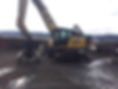 A large excavator parked in a junkyard