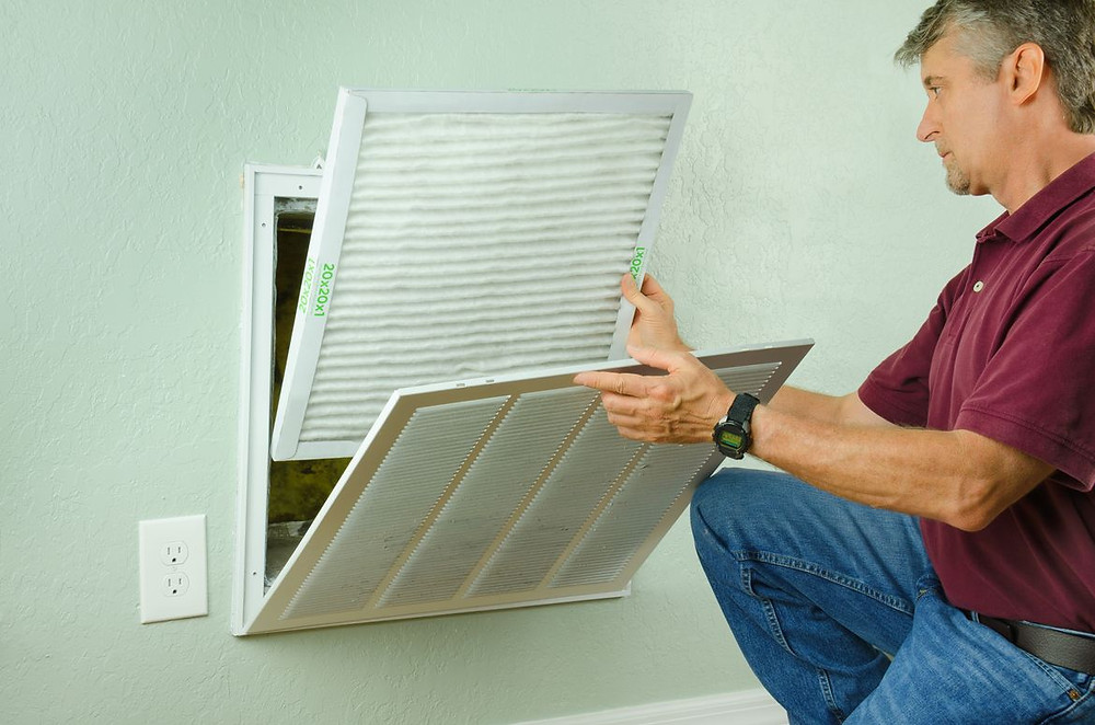 a person changing air filters