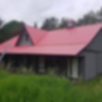 A picture of a red and grey coloured house constructed in a hut-like structure