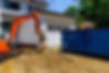 A family house is being rebuilt with the help of an excavator