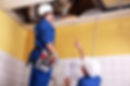 Service technicians examining ceiling vents
