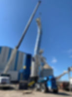 A crane lifting a section of pipe