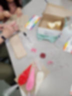 An image showing a teacher and a child decorating cookies