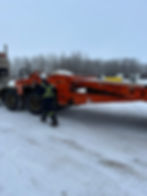 A worker beside the vehicle recovery equipment