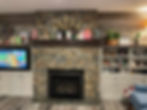a fireplace, a TV, and a shelf