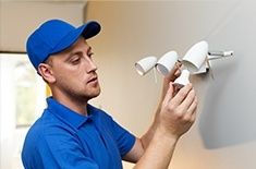 man fixing a light