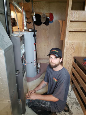 man sitting next to HVAC installations.jpeg