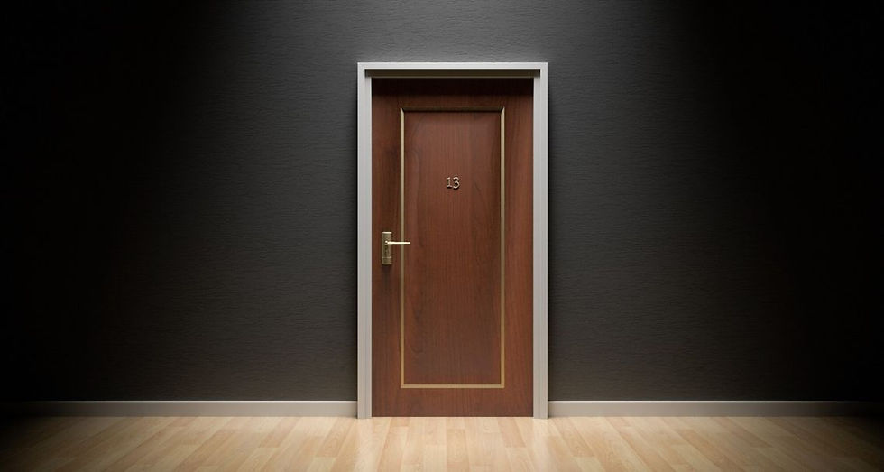 A wooden door in a black wall