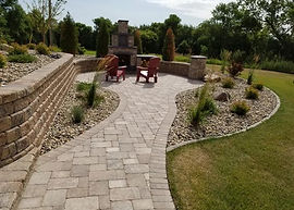 Multicoloured flowering plants in front of a wooden fence