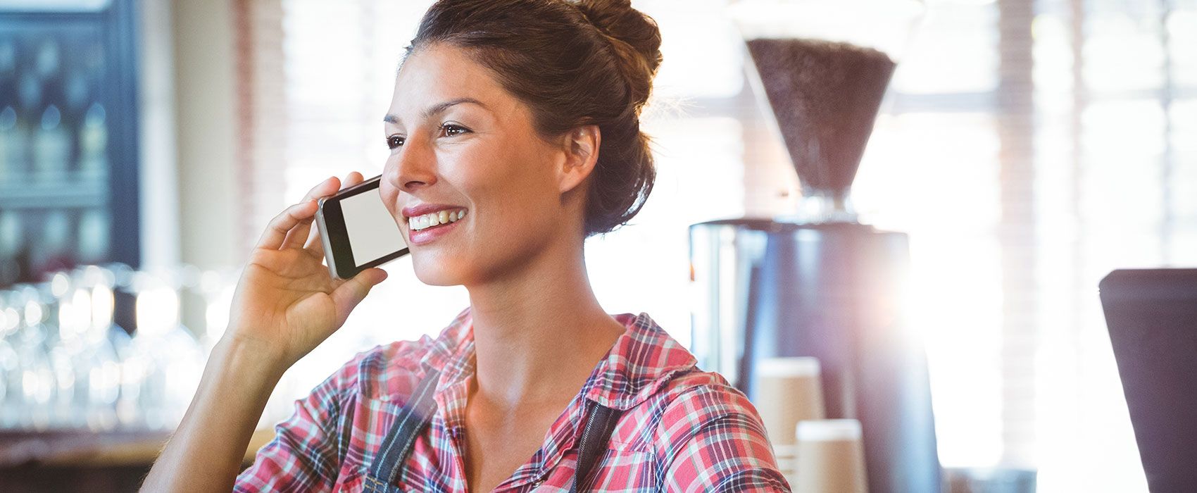 smiling young woman talking on mobile phone
