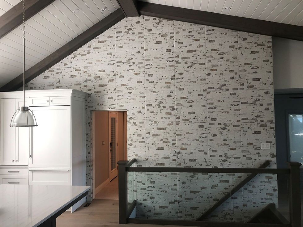 Interior view of a common area of a house with stone wall and hardwood floor