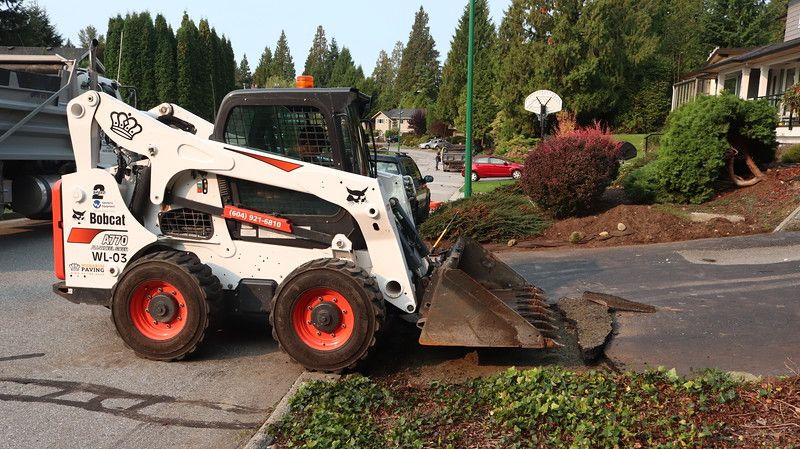 excavator removing asphalt