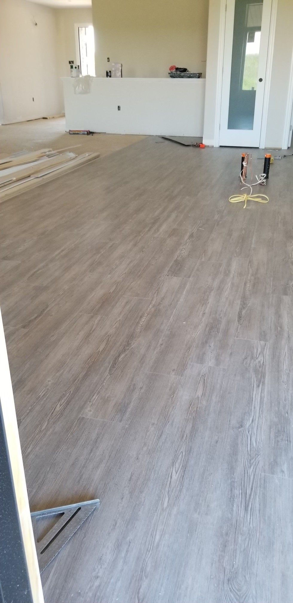 Interior view of a living room under construction with hardwood flooring