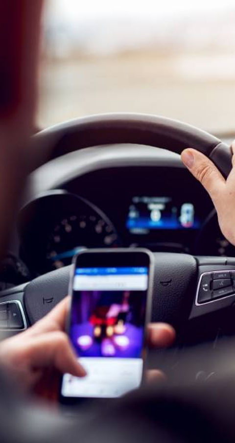 someone looking at their phone while driving