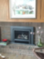 Fireplace with books and vase beside it