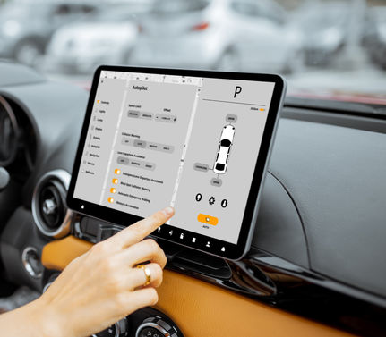 Touchscreen for a fully integrated system in a car with a hand on it