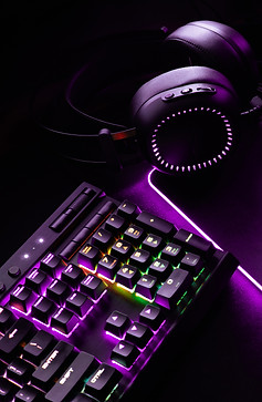 Over the ear headphones on a LED lit computer keyboard