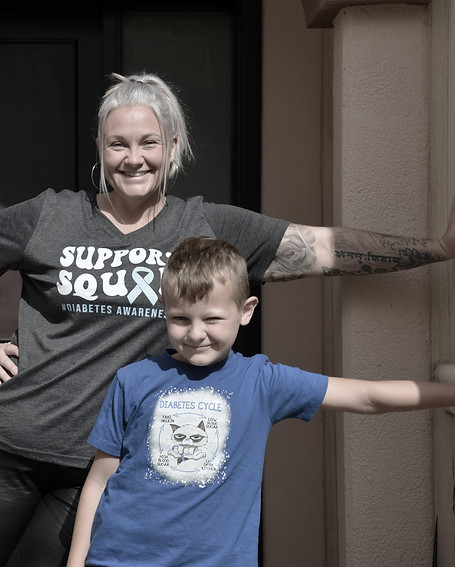 Doorway photo with blog author and her diabetic son, both individuals wearing diabetes related t-shirts