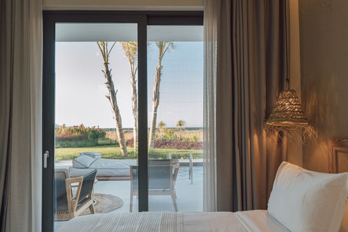 Embark on an unforgettable vacation at Taf Villas, a luxurious beach resort on Greece's enchanting Kos Island, where you can indulge in the comfort of a premium 1-bedroom villa, enjoy the mesmerizing views from the infinity pool, and experience the epitome of upscale accommodation in this idyllic hotel setting.The master bedroom in the villa is a luxurious retreat.