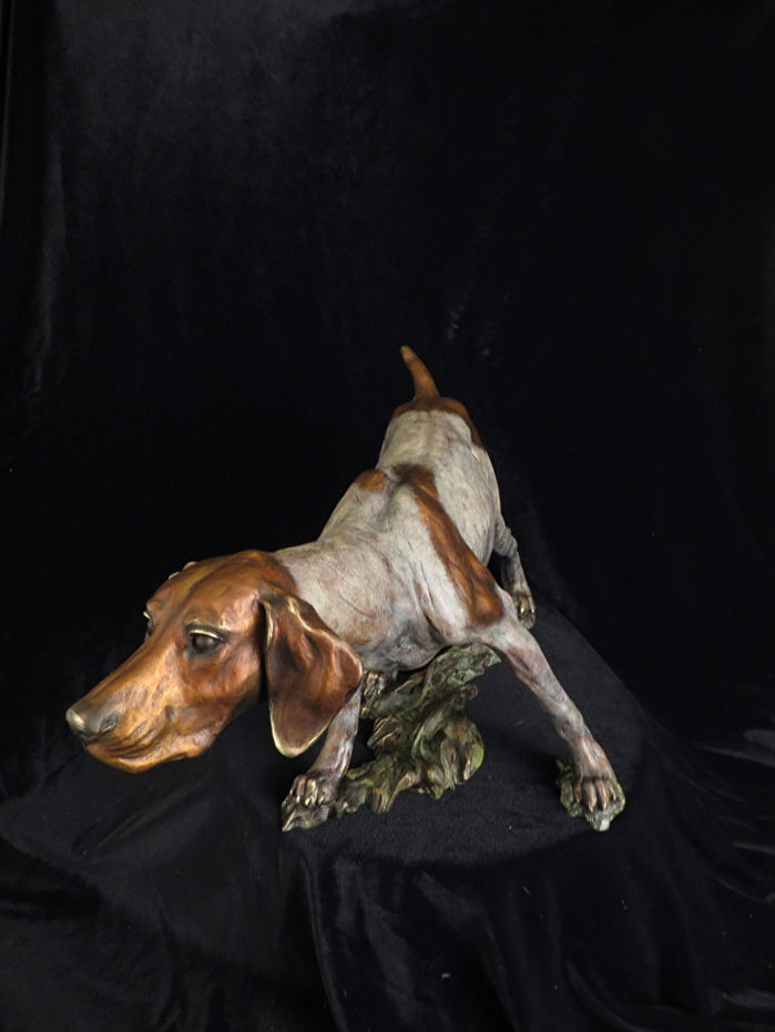 Bronze dog statue on a black background, art sculpture with detail
