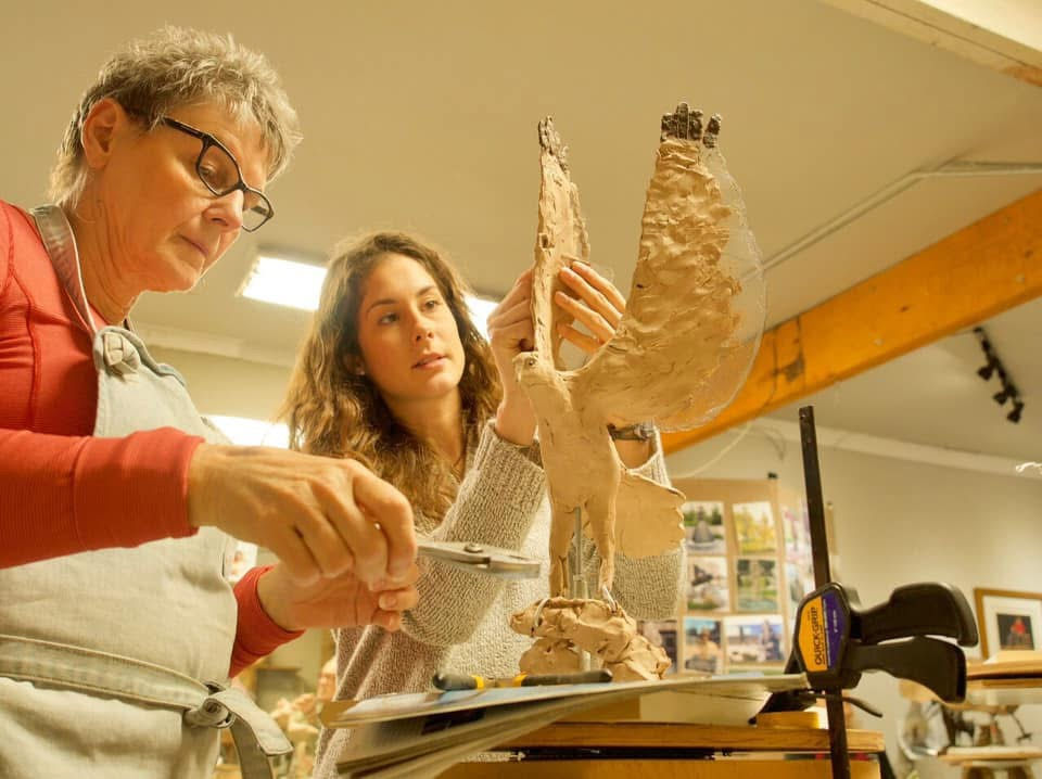 Kristen giving personalized one-on-one coaching during class
