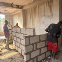 Cement blocks stacked on construction site of new hotel project in Ghana, led by Twyla Garrett.