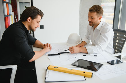 two-young-architects-with-blueprints-of-a-house-st-2025-03-14-20-57-53-utc.jpg