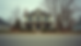 Eye-level view of a quiet Culpeper neighborhood street with a vacant house in the center